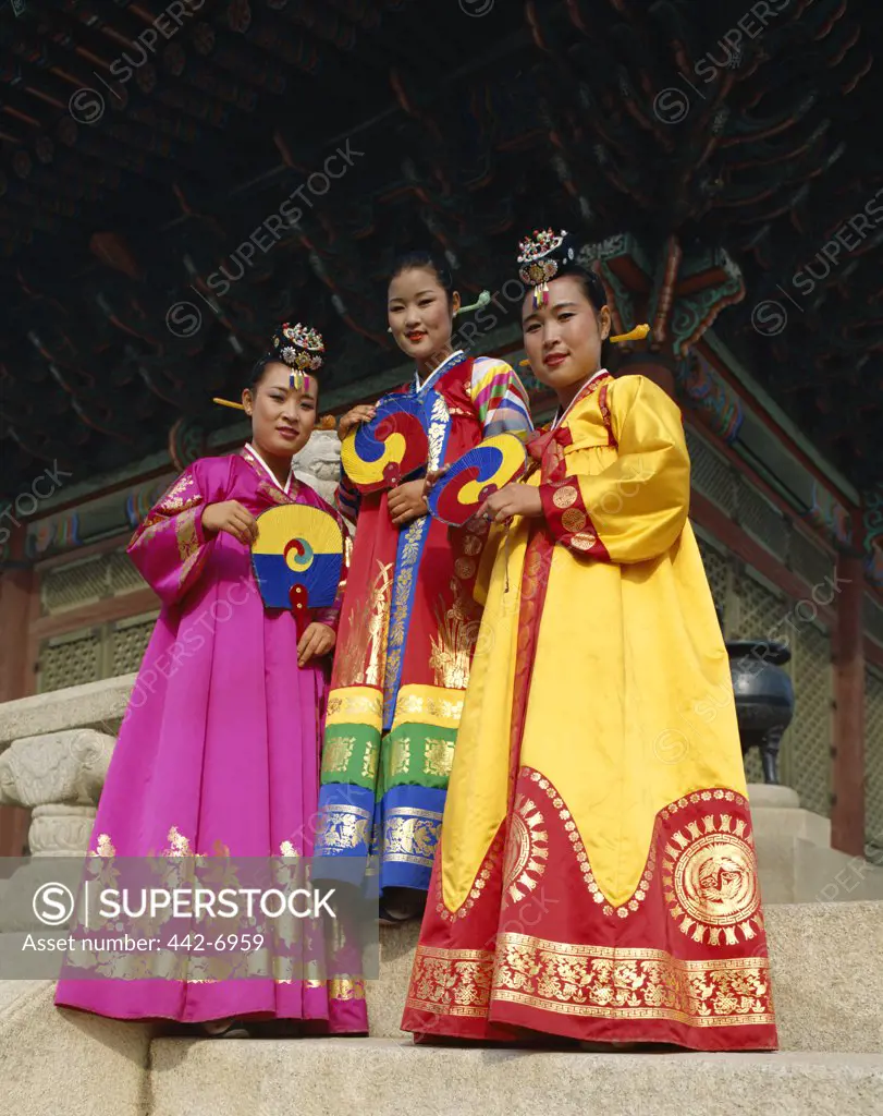 Low angle view of three women in traditional costumes, Seoul, South Korea