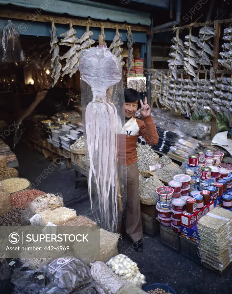 Portrait of a teenage boy selling dried seafood in a market, Seoul, South Korea