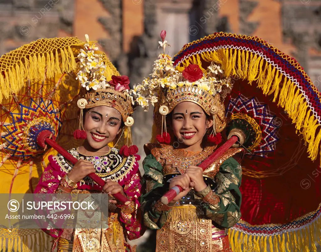 Portrait of two Legong dancers dressed in traditional costumes, Bali, Indonesia