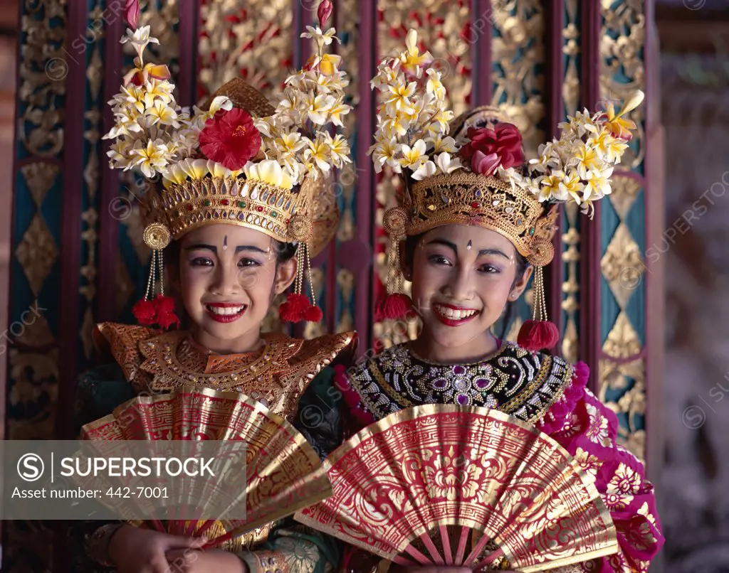 Portrait of two Legong dancers dressed in traditional costumes, Bali, Indonesia