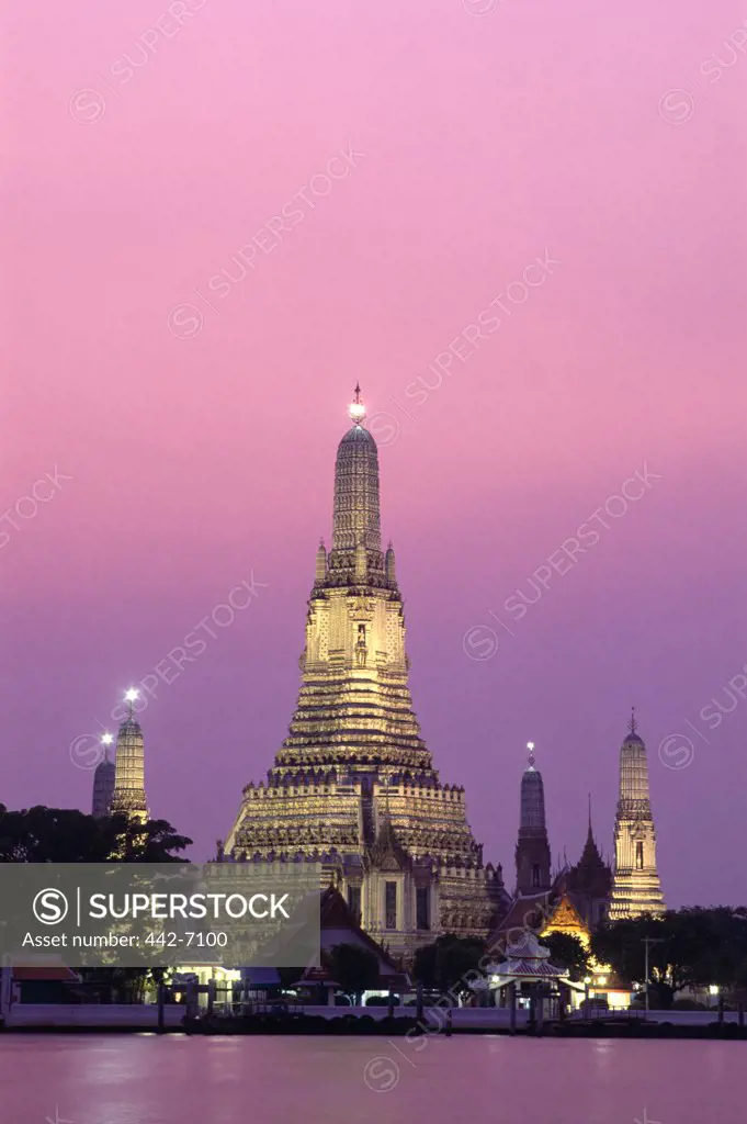Sunset over a temple, Wat Arun, Chao Phraya River, Bangkok, Thailand