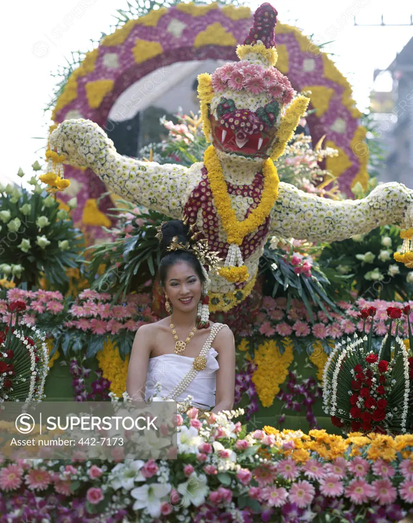 Young woman dressed in a traditional Thai costume sitting on a float, Floral Floats, Flower Festival, Chiang Mai, Golden Triangle, Thailand