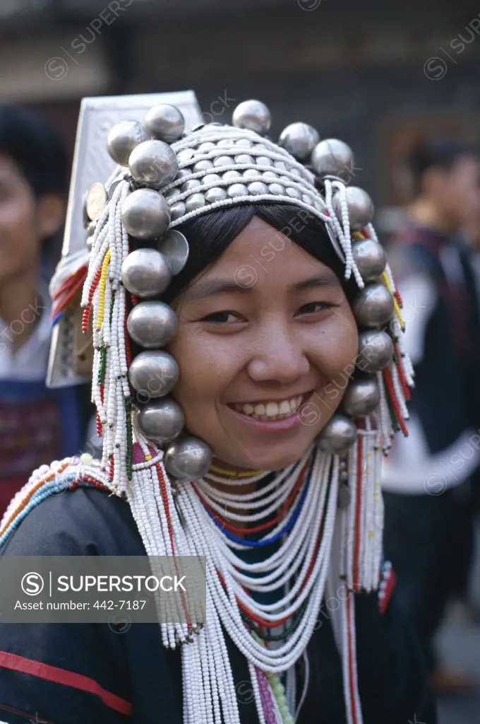 Portrait of a mid adult woman wearing an ornate headdress, Akha Tribe, Chiang Mai, Golden Triangle, Thailand