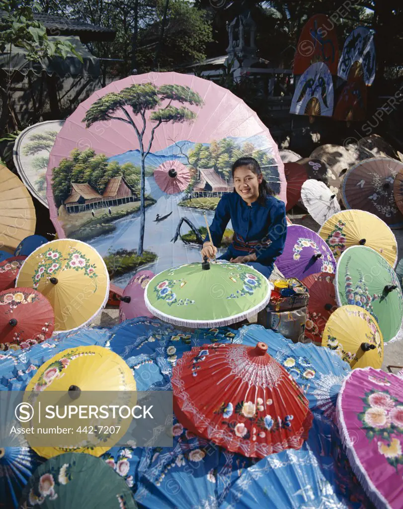 Portrait of a young woman painting parasols, Bo Sang, Chiang Mai, Golden Triangle, Thailand