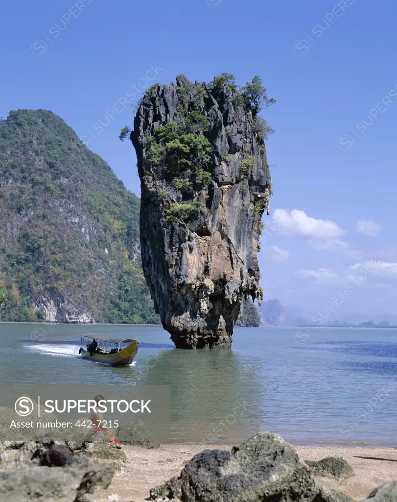 Woman sitting on a rock at James Bond Island, Phangnga Bay, Phuket, Thailand