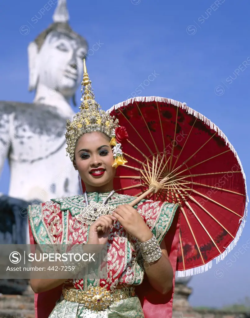 Portrait of a teenage girl dressed in a traditional dancing costume at a temple, Wat Mahathat, Sukhothai, Thailand