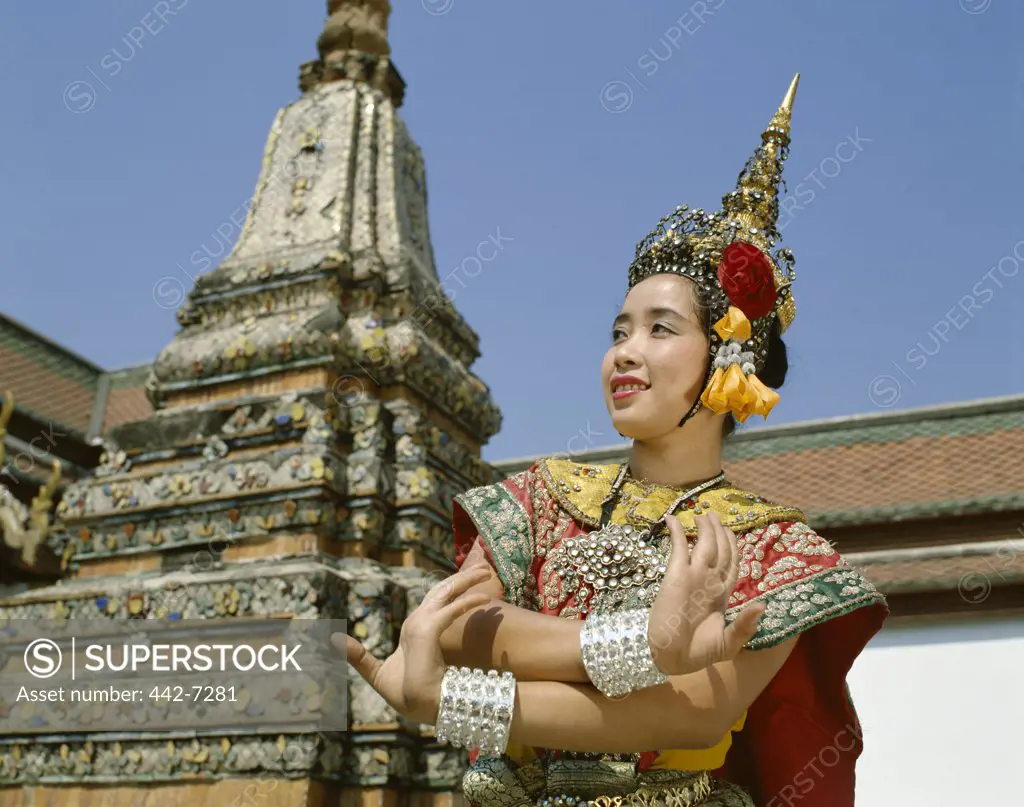 Low angle view of a teenage girl dressed in a traditional dancing costume, Bangkok, Thailand