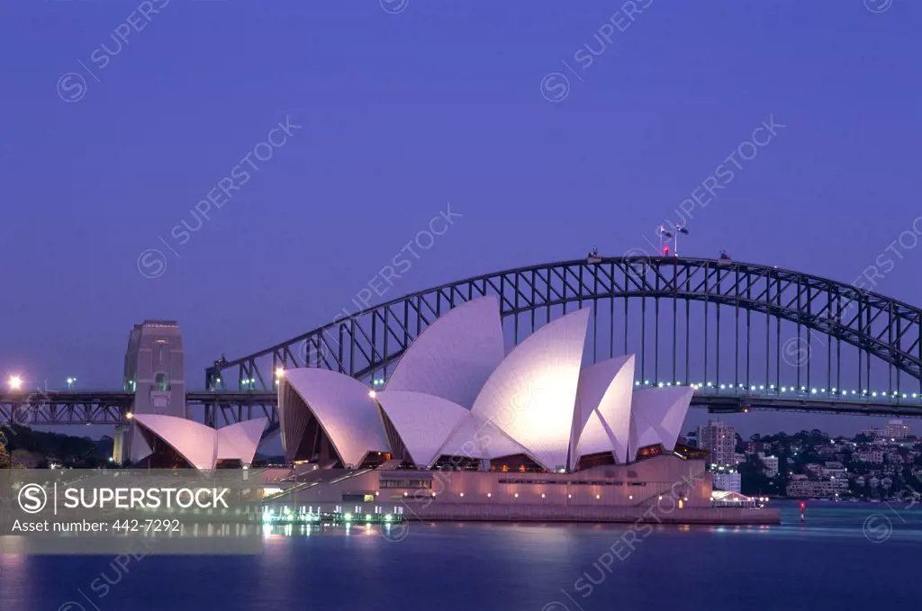 Opera house lit up at dusk, Sydney Opera House, Sydney Harbor Bridge, Sydney, Australia