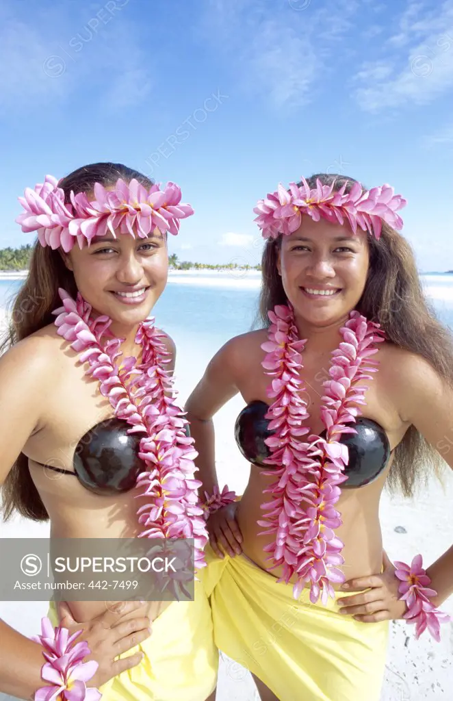 Portrait of two teenage girls dressed in traditional costumes with leis, Aitutaki Island, Cook Islands, Polynesia