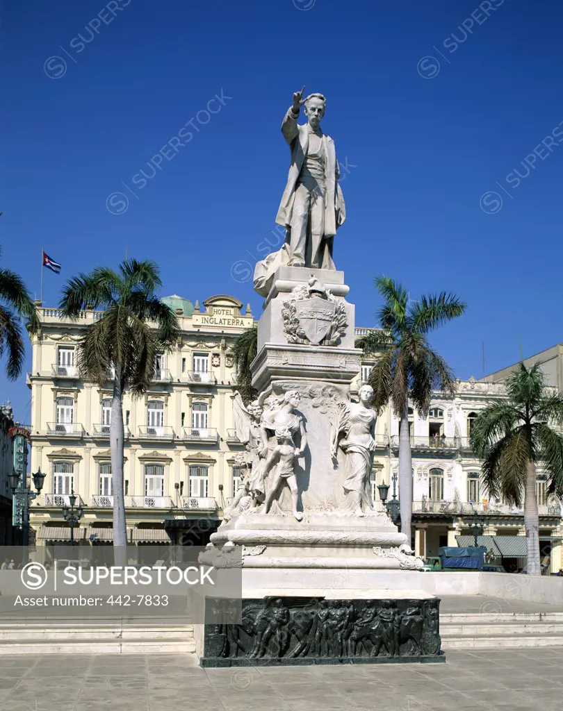 Low angle view of a statue and hotel, Jose Marti Statue and Hotel Inglaterra, Havana, Cuba