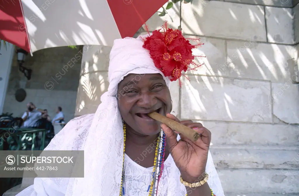 Portrait of a mature woman smoking a cigar, Havana, Cuba