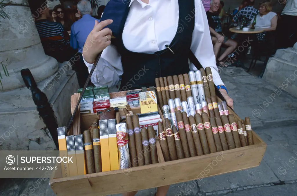 Mid section view of a female cigar vendor, Havana, Cuba