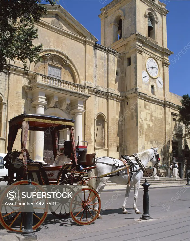 Horse carriage in front of a cathedral, St. John's Cathedral, Valletta, Malta