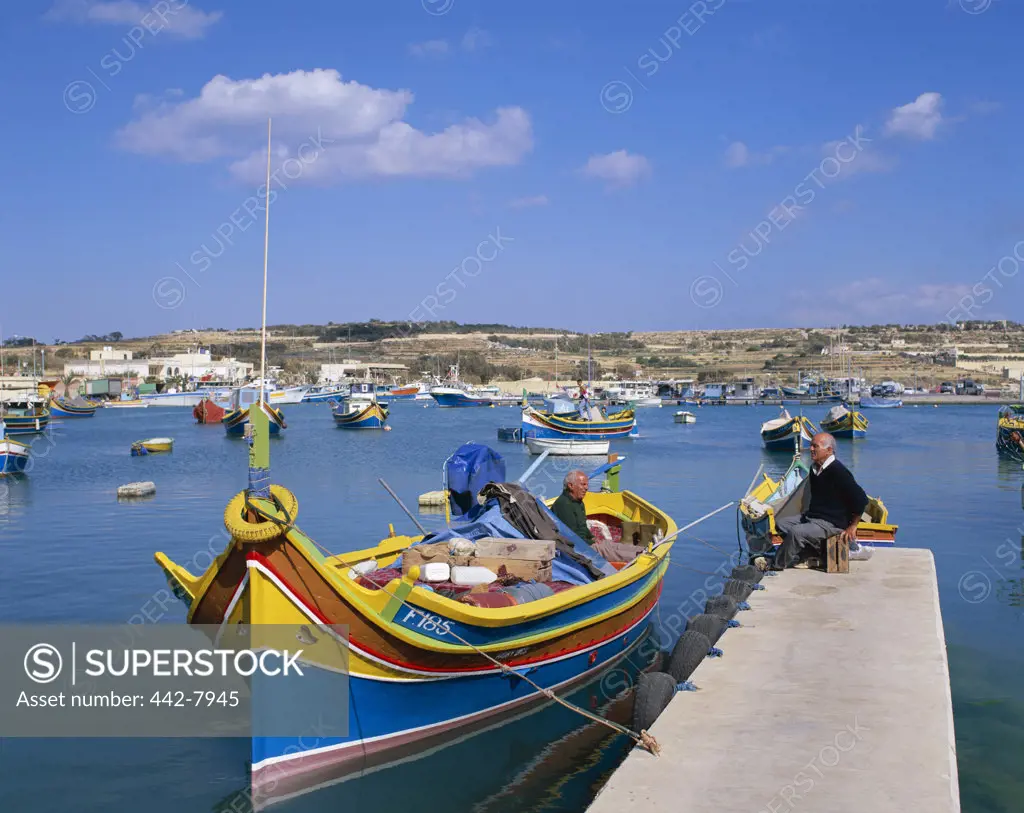 Fishing boats docked in a harbor, Marsaxlokk, Malta