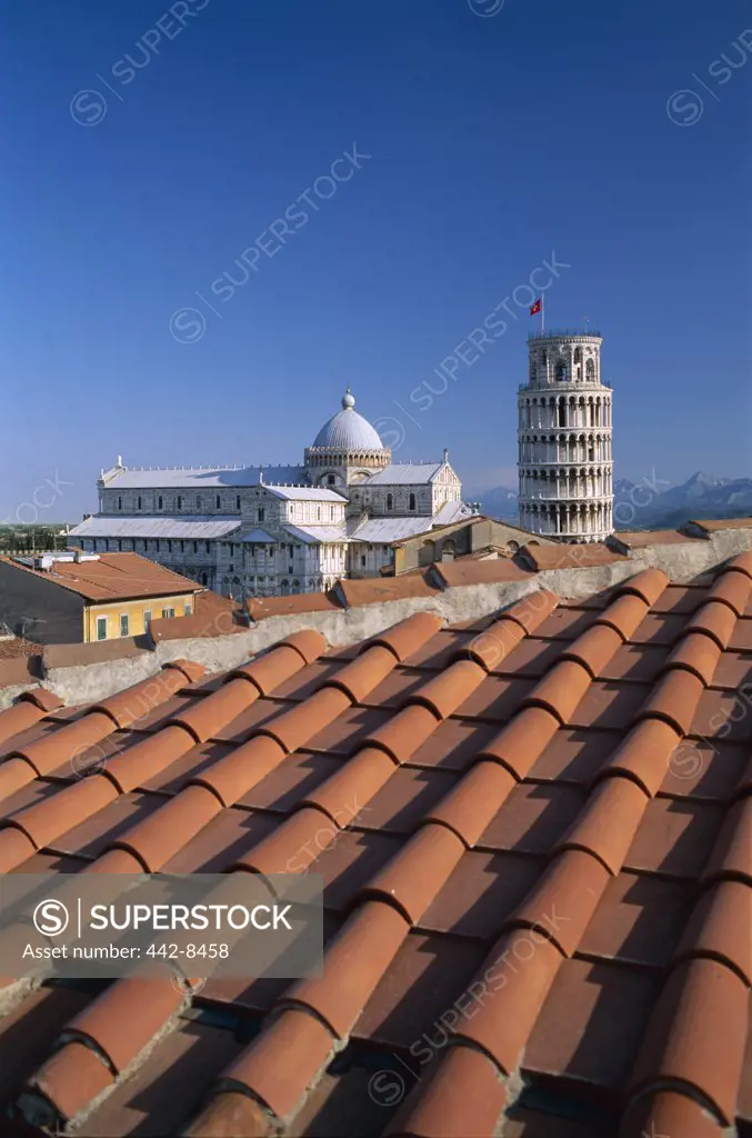 Close-up of a tiled rooftop in front of buildings, Leaning Tower, Pisa, Italy