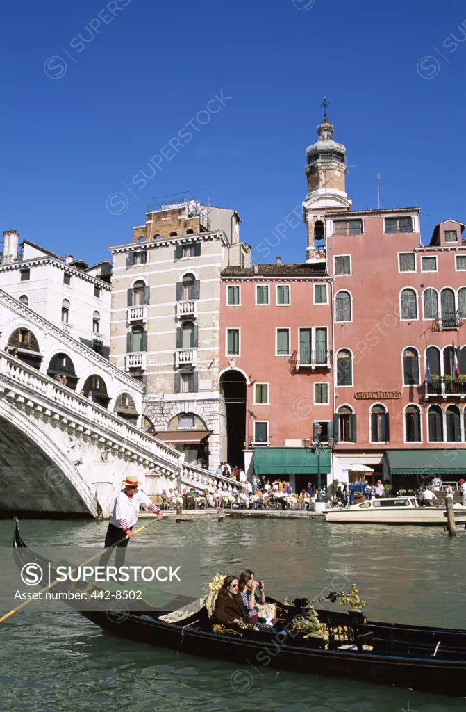 People on a gondola near a bridge, Rialto Bridge, Grand Canal, Venice, Italy