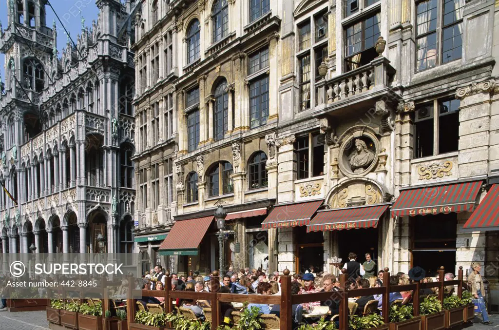 Tourists sitting at an outdoor cafe, Grand Place, Brussels, Belgium