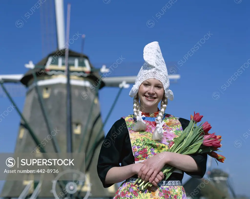 Girl Dressed in Dutch Costume in front of Windmill, Zaanse Schans, Netherlands