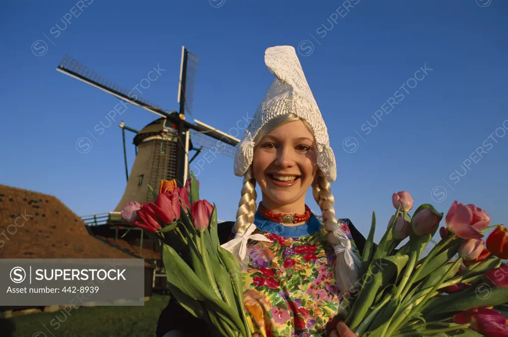 Girl Dressed in Dutch Costume in front of Windmill, Zaanse Schans, Netherlands
