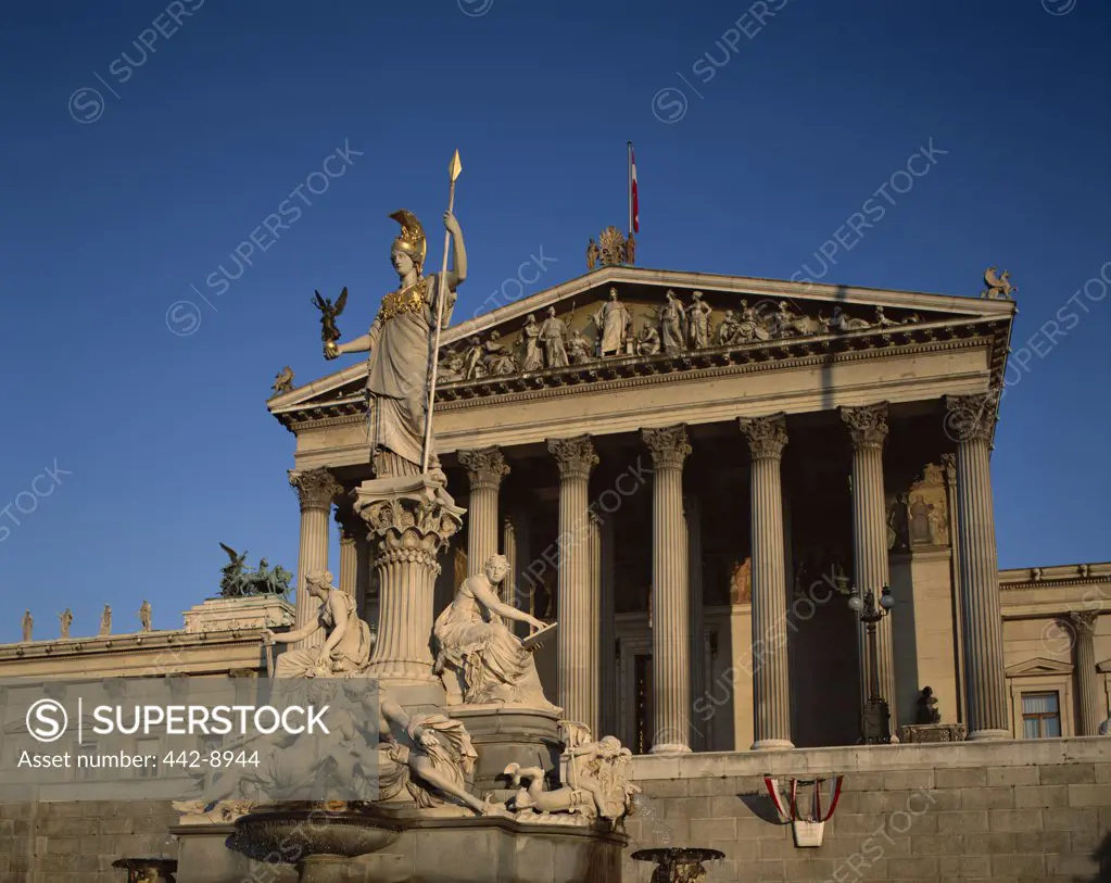 Low angle view of a statue in front of a government building, Parliament Building, Vienna, Austria