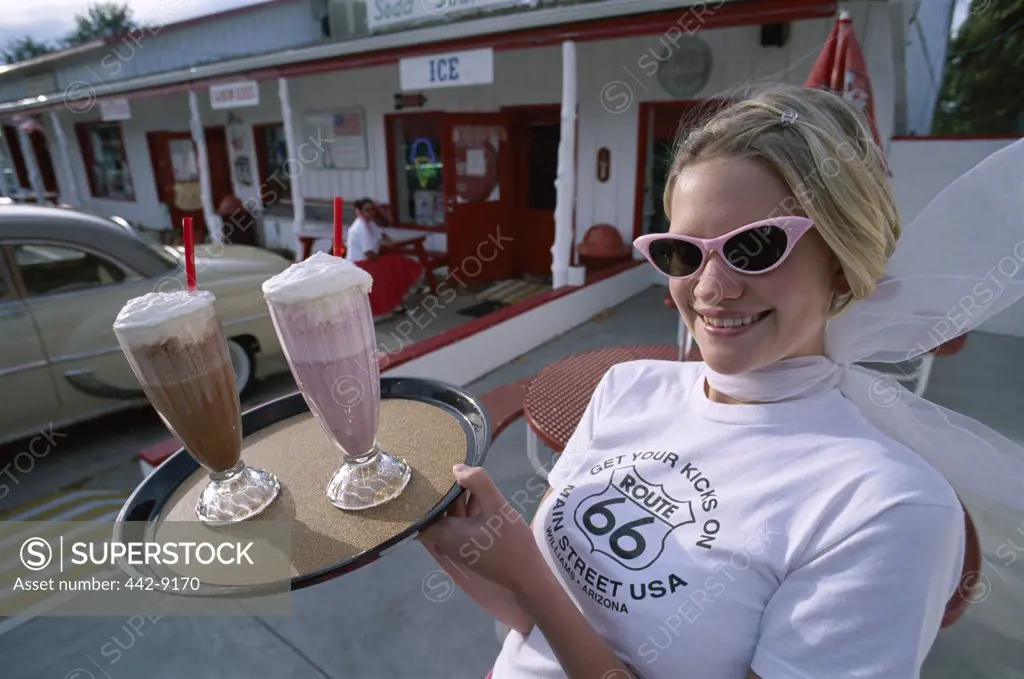 Waitress holding a tray with ice cream floats, Twisters Soda Fountain, Route 66, Williams, Arizona, USA