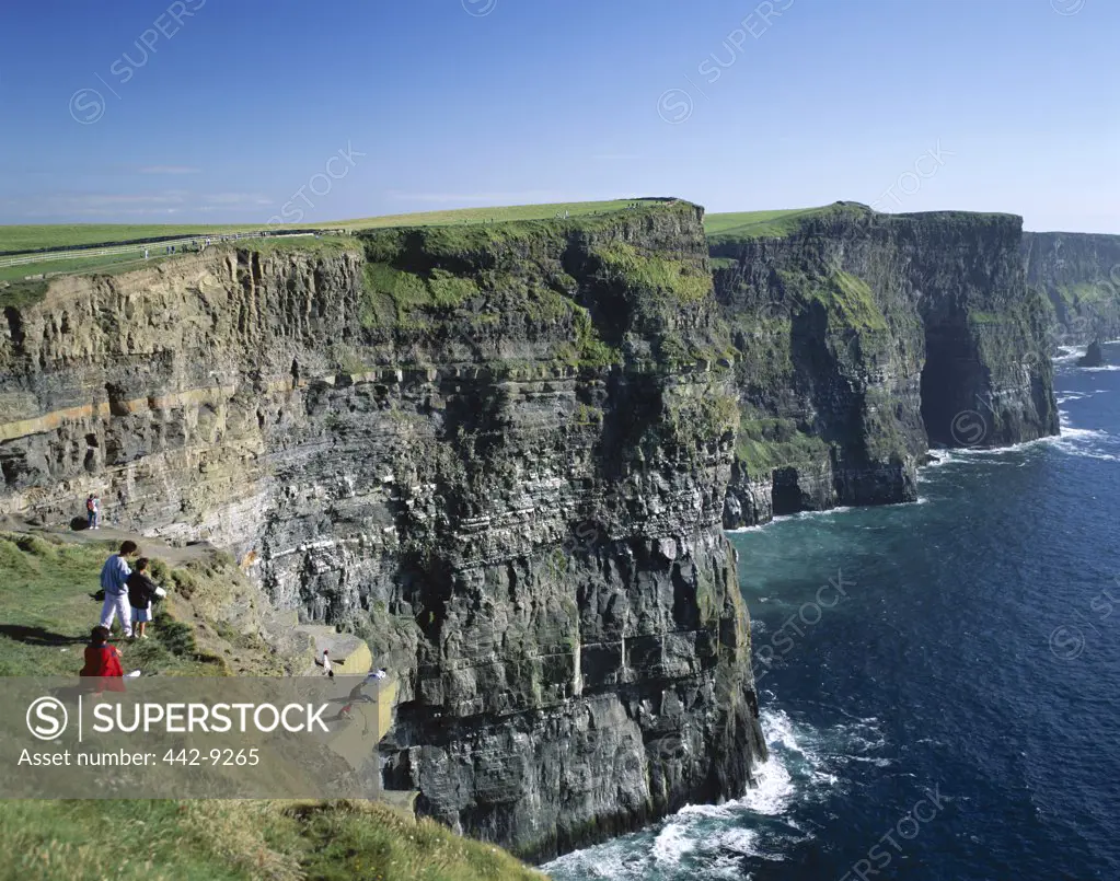 Tourists on a cliff, Cliffs of Moher, County Clare, Ireland