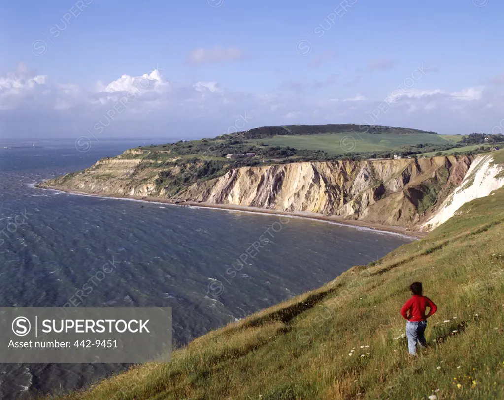 Rear view of a person standing on a hill, Alum Bay, Isle of Wight, England