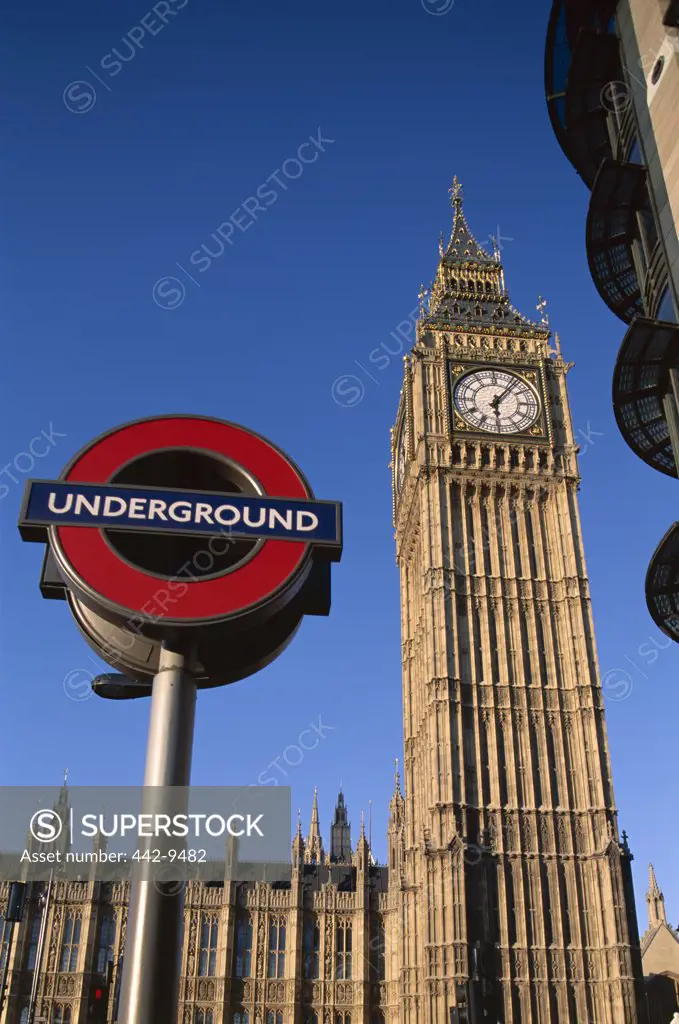 Low angle view of Underground subway sign in front of Big Ben, London, England