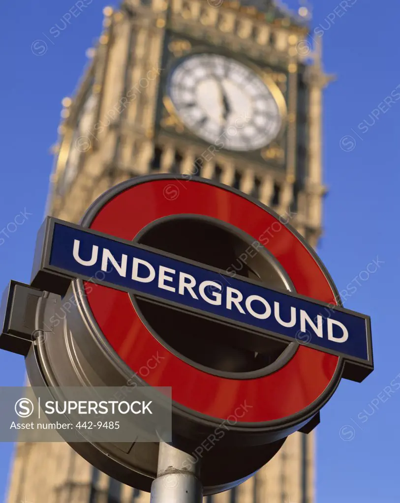 Low angle view of Underground subway sign in front of Big Ben, London, England