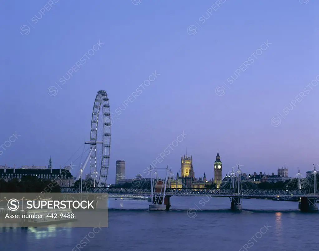 London Eye and Houses of Parliament at dusk, Thames River, London, England