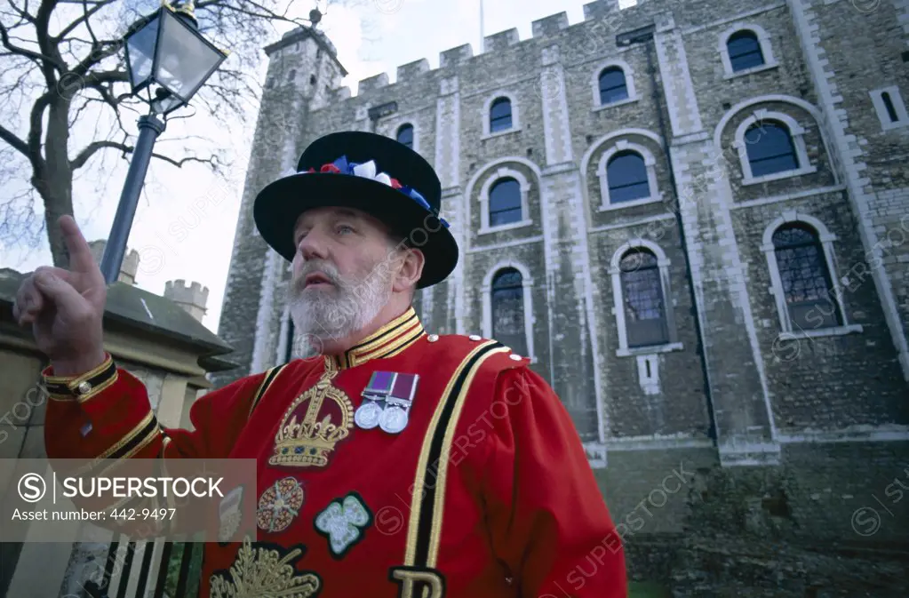 Close-up of a Beefeater standing in front of the Tower of London, London, England