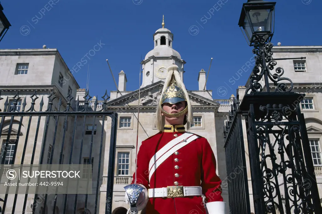 Low angle view of a horse guard standing in front of a gate, London, England