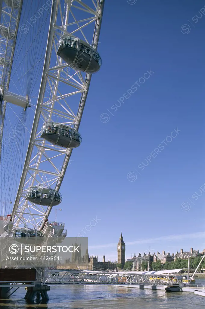 Low angle view of London Eye and Houses of Parliament, London, England