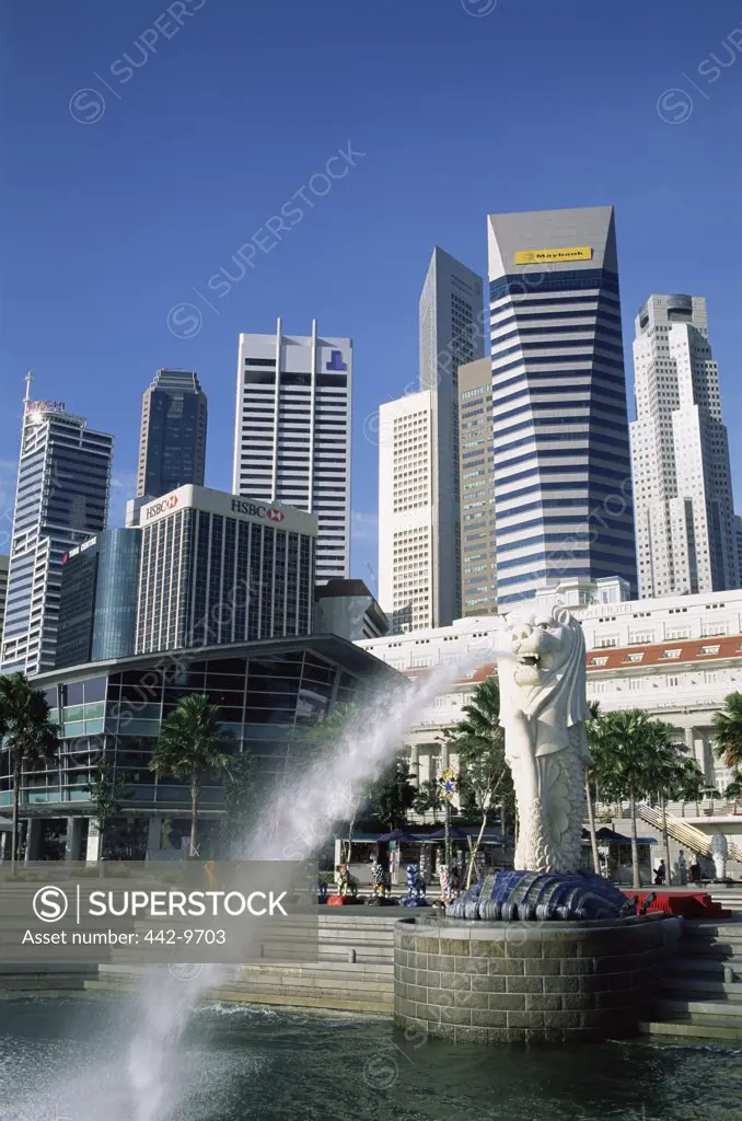 Low angle view of skyscrapers on the waterfront, Merlion Statue, Singapore