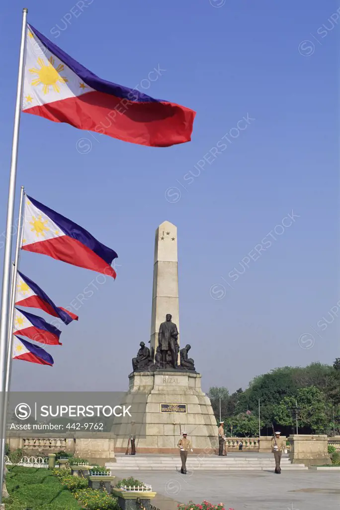 Low angle view of flags fluttering in a row, Rizal Memorial, Manila, Philippines