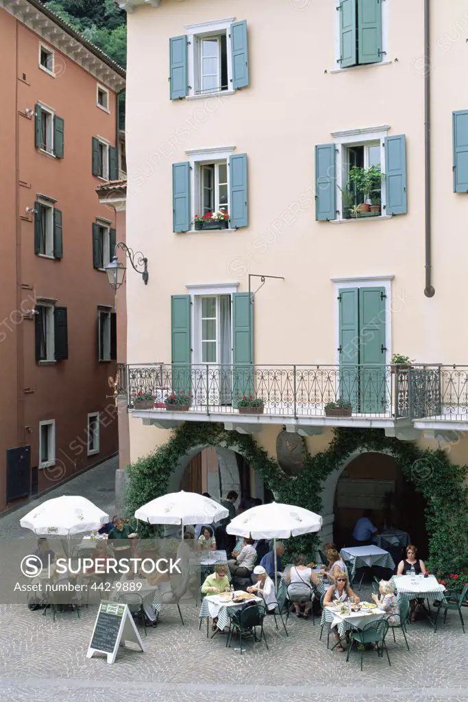 High angle view of tourists sitting at a sidewalk cafe, Riva del Garda, Italy