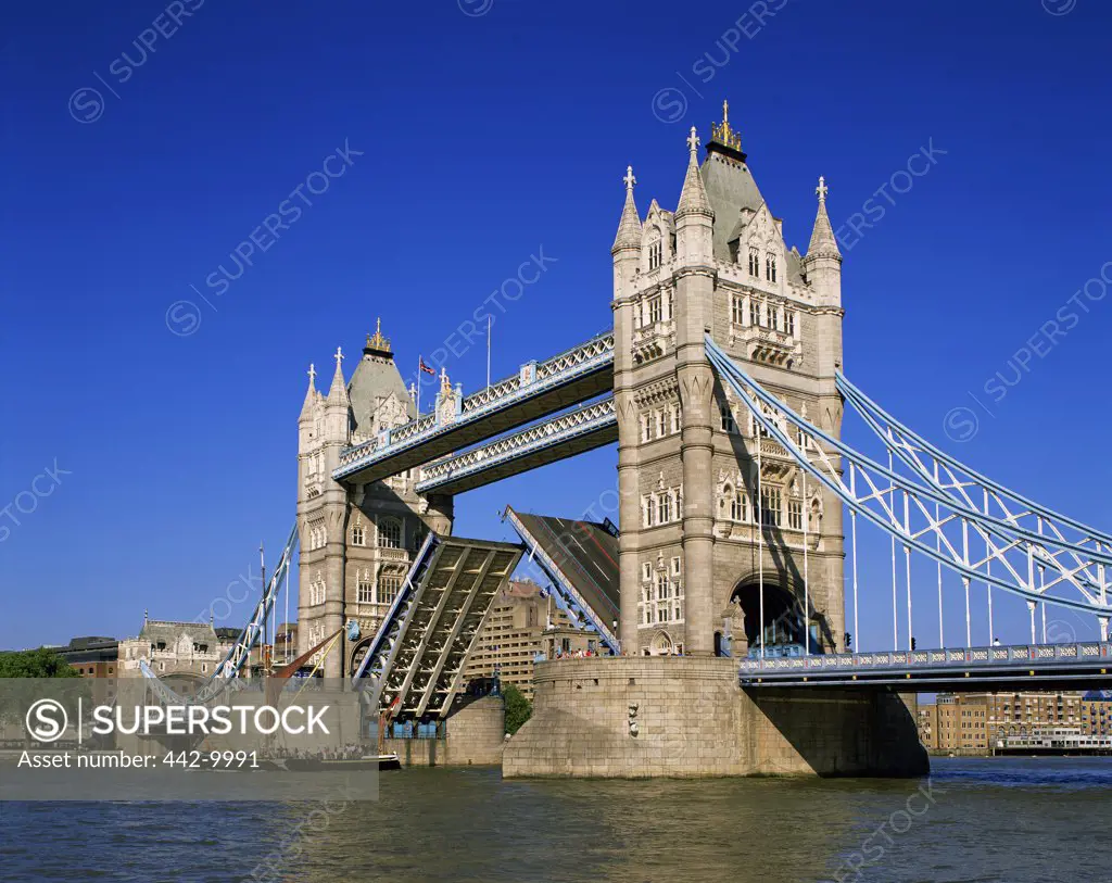 Low angle view of a drawbridge across a river, Tower Bridge, London, England
