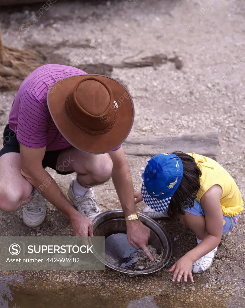 High angle view of two people panning for gold, Sovereign Hill Mining Village, Ballarat, Melbourne, Australia
