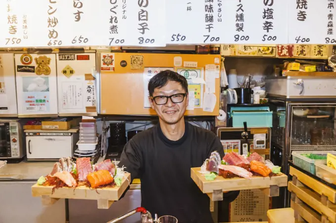 Japan, Honshu, Tokyo, Restaurant Owner Serving Sashimi