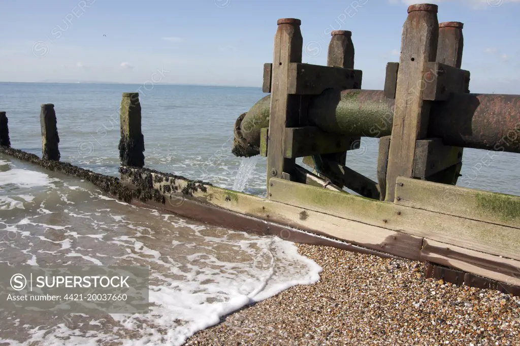 Sewer overflow pipe, sanitary sewage and stormwater runoff discharged onto beach, East Wittering, Manhood Peninsula, West Sussex, England, March