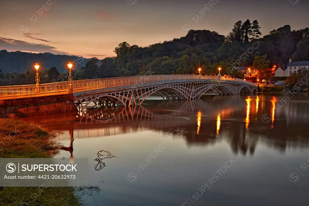 Bridge over river during high tide at dusk, Old Wye Bridge, Chepstow, River Wye, Wye Valley, Monmouthshire, Wales, September