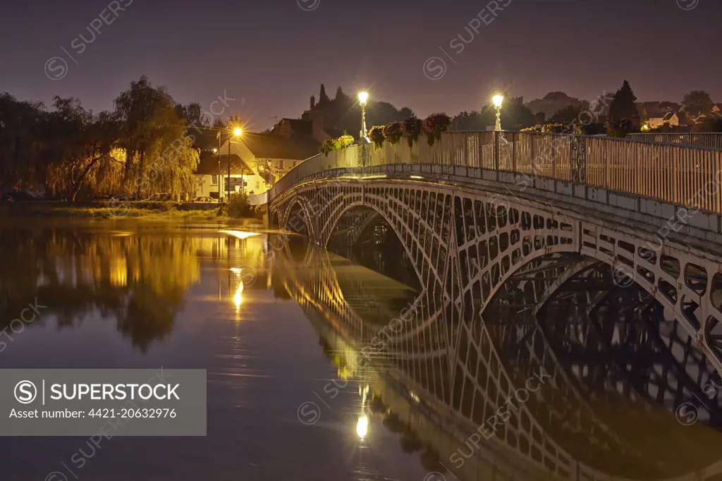 Bridge over river during high tide at twilight, Old Wye Bridge, Chepstow, River Wye, Wye Valley, Monmouthshire, Wales, September
