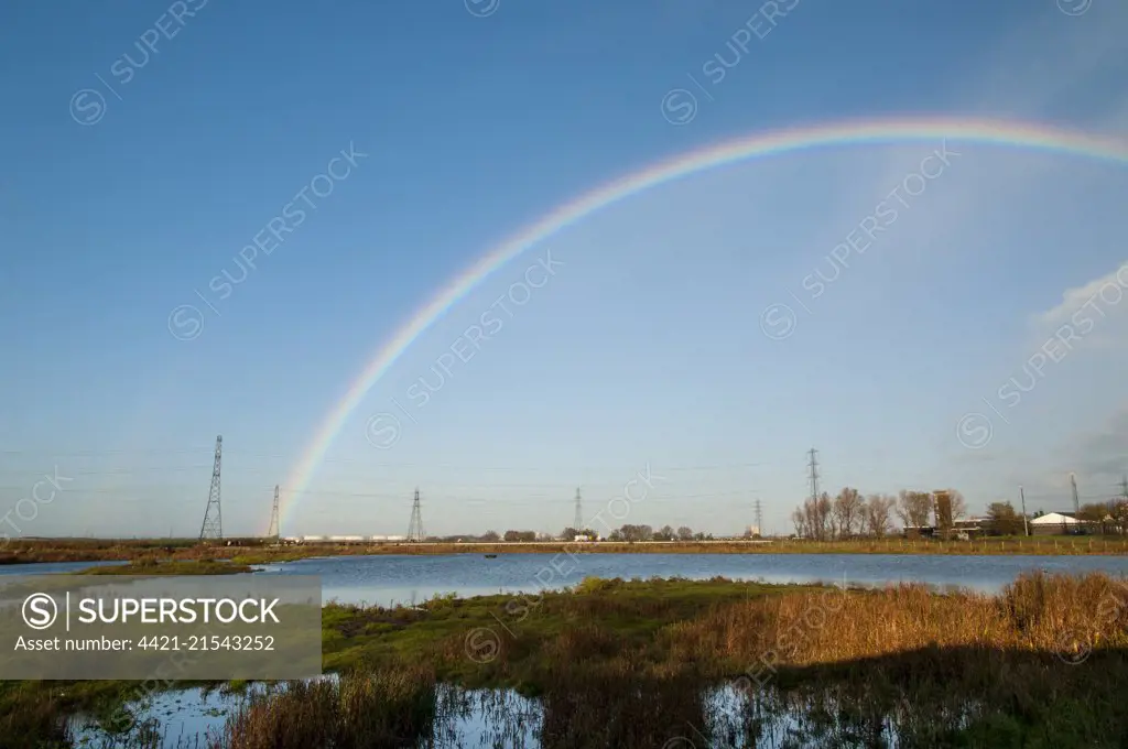 A view of wetland habitat under a rainbow at RSPB Saltholme, Middlesbrough, Teesside. October.