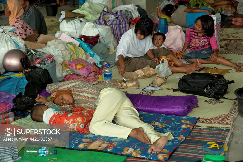 Refugees from recent volcanic eruption, resting in temperary accommodation of stadium, Maguwo, Mount Merapi, Central Java, Indonesia, november 2010