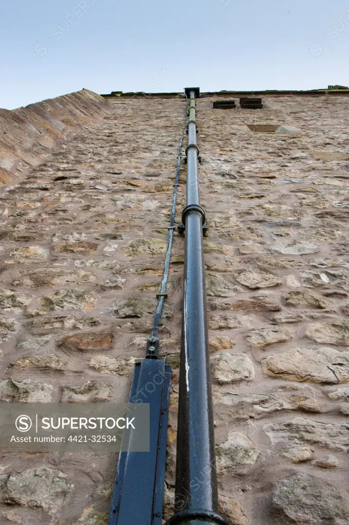 Lightning conductor beside drain pipe on church tower, St. Bartholomew's Church, Chipping, Forest of Bowland, Lancashire, England, november
