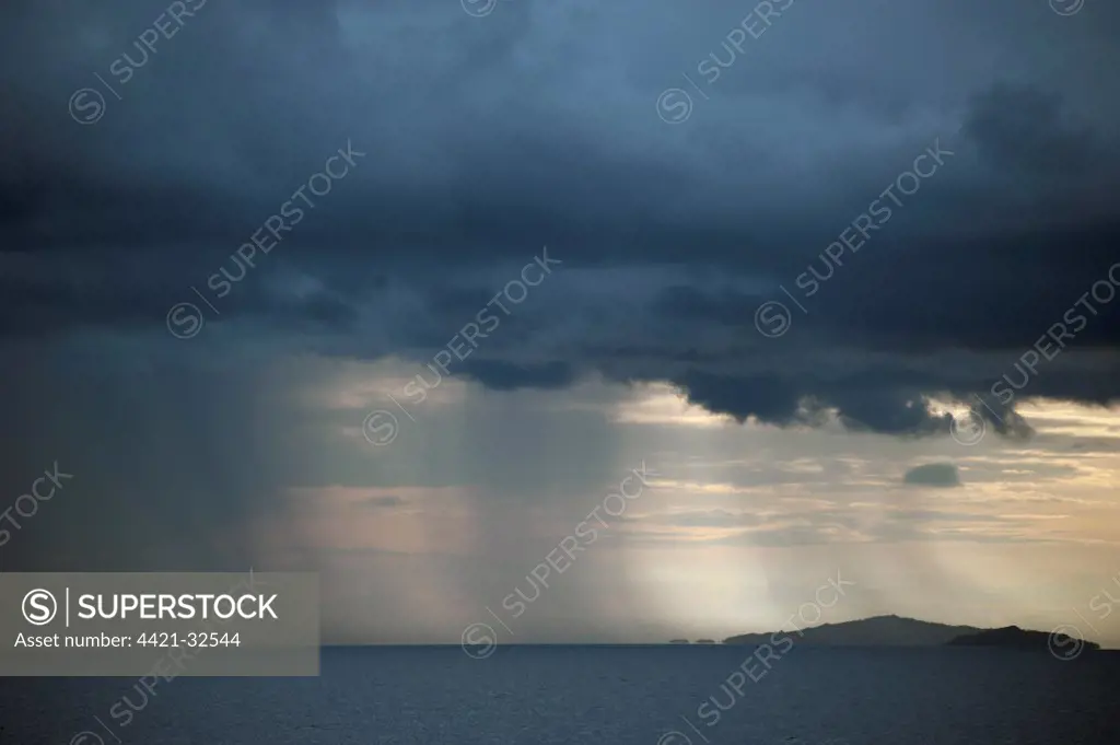Rainstorm approaching over sea at dusk, Raja Ampat Islands (Four Kings), West Papua, New Guinea, Indonesia, december