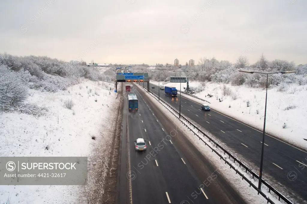 M60 Motorway with traffic in snow, Denton, Manchester, England, winter