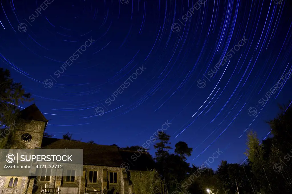 Stars revolving around Polaris (Pole Star) over church at night, Farnborough Church, Farnborough, Kent, England, october (195 thirty second exposures blended together using 'Startrails' software)