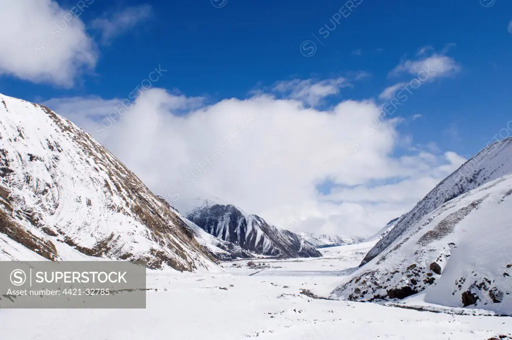 View along snow covered mountain valley, looking towards Kazbegi, Great Caucasus, Caucasus Mountains, Georgia, april