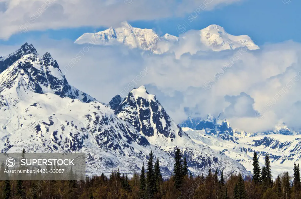View of snow covered mountains in low cloud, Mt. Hunter, Alaska Range, Denali N.P., Alaska, U.S.A., may